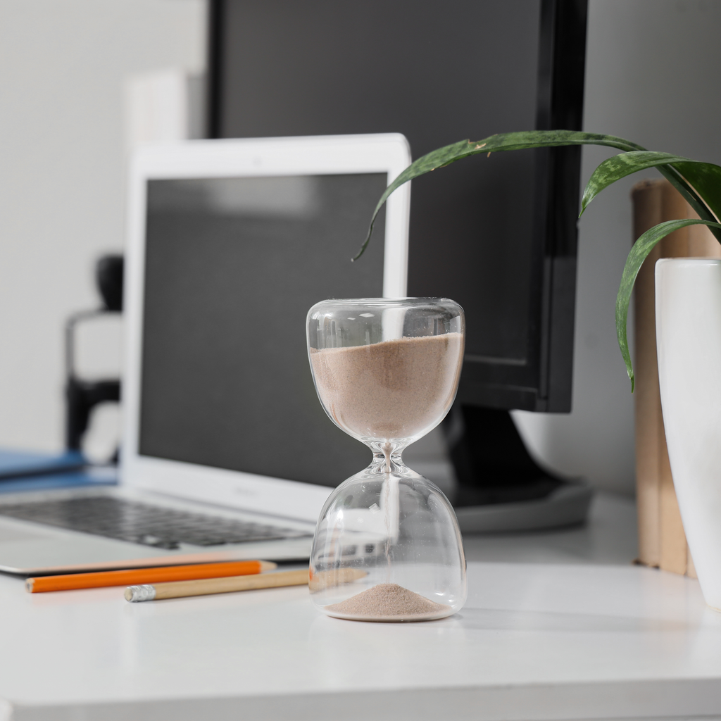 nutritions Minimalist desk timer resting beside a laptop and a daily planner with a single completed task